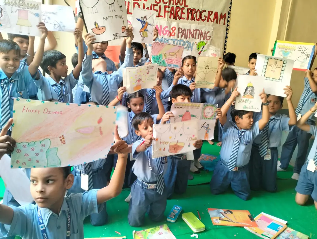 Students holding up their drawings at a painting competition