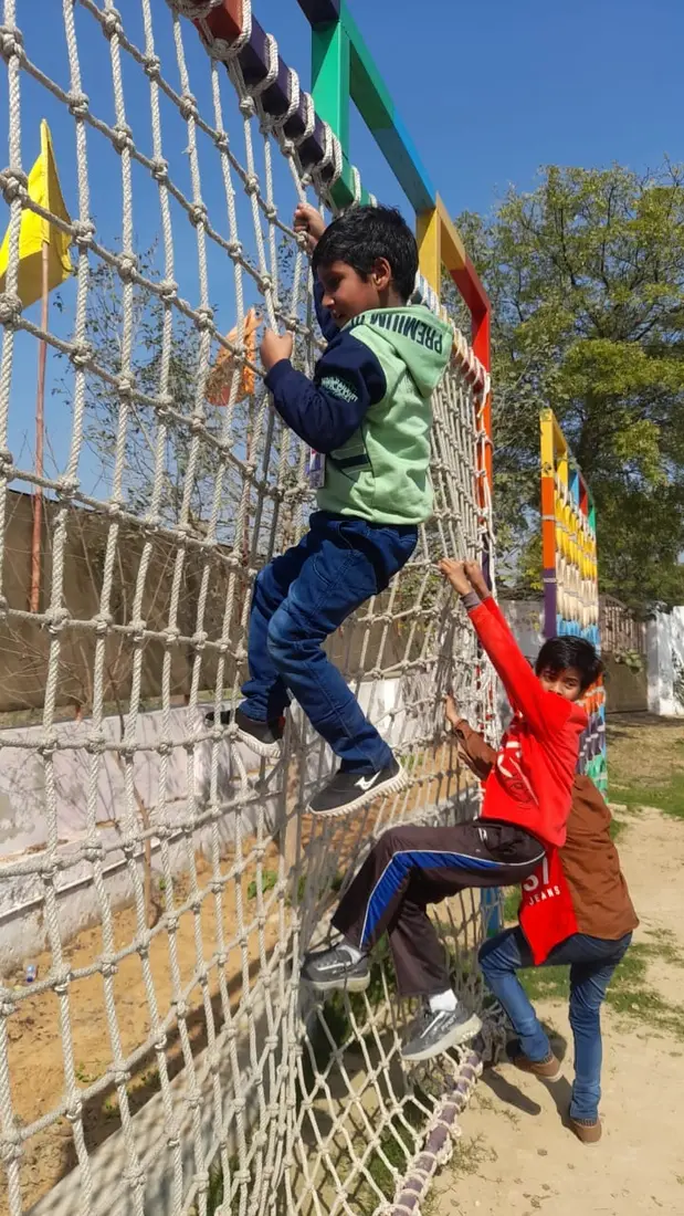 Students climbing the net on sports day